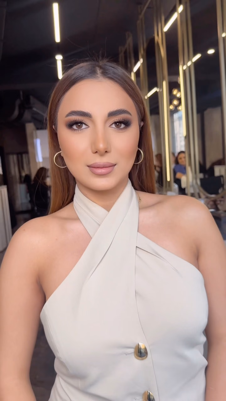 Classic evening makeup with defined brows, lifted liner and a soft nude lip